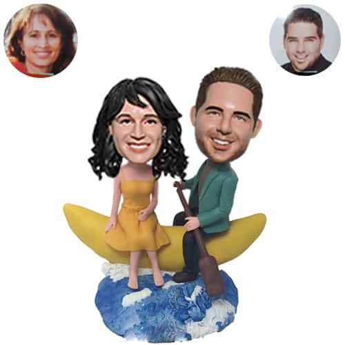 Custom bobbleheads wedding sitting on moon boat