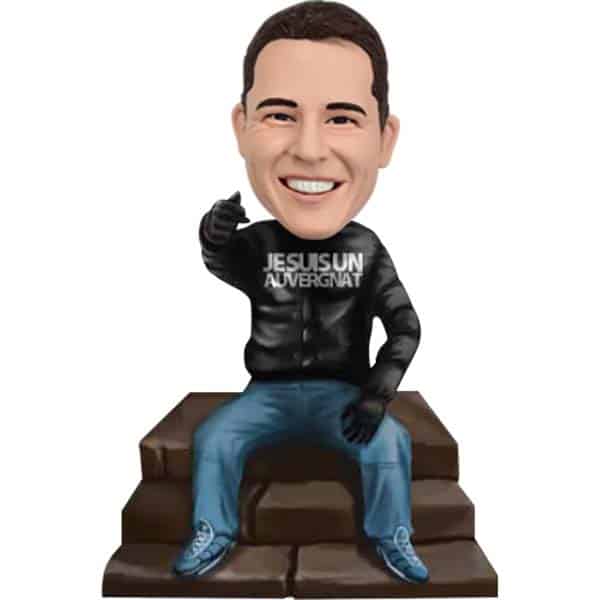 Personalized bobblehead sitting on steps