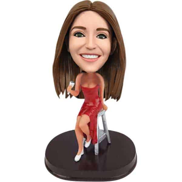 Bobblehead in red dress with martini