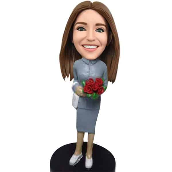 Bobblehead dolls with flowers in hand