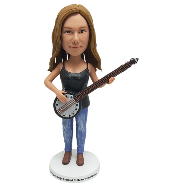 Female bobblehead cake topper playing banjo