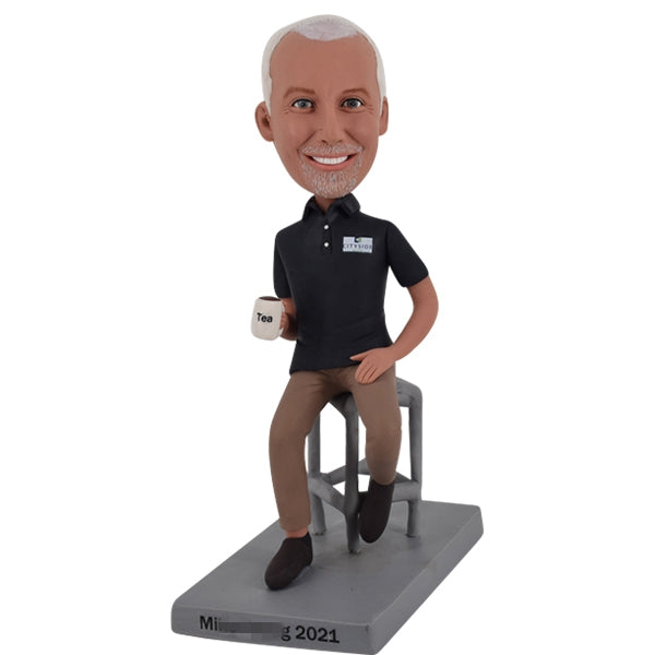 Male Bobble Head on Stool holding Coffee Mug