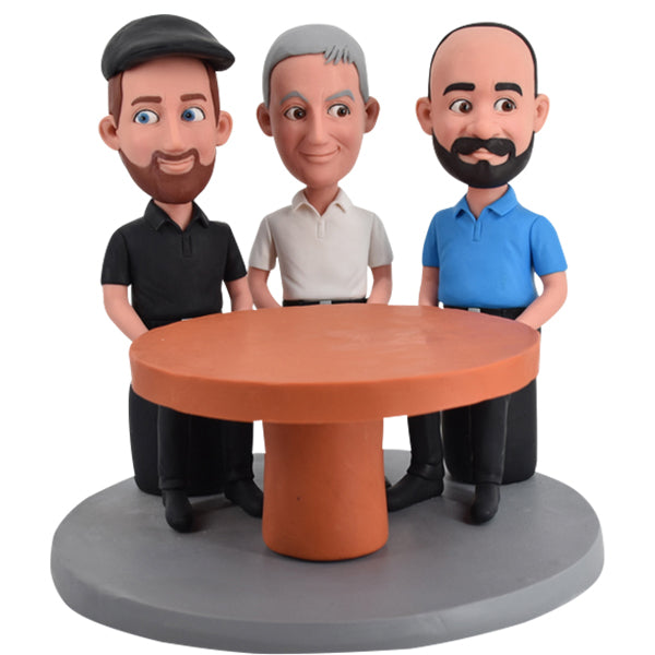 Three men Bobbleheads sitting before desk