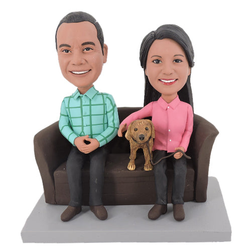 Custom man and woman bobbleheads sitting in couch