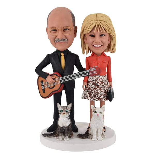 Couple Bobbleheads playing guitar with cats